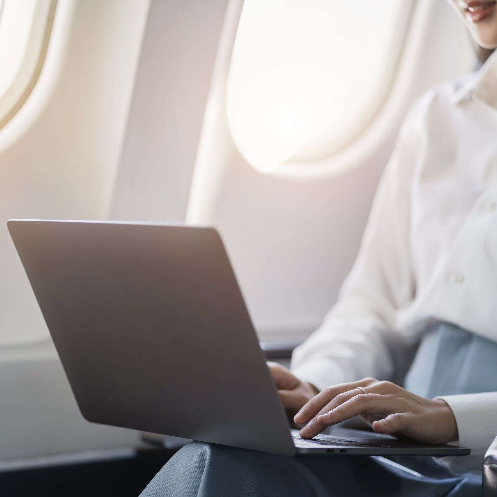 Traveling,And,Technology.,Young,Business,Woman,Working,On,Laptop,Computer